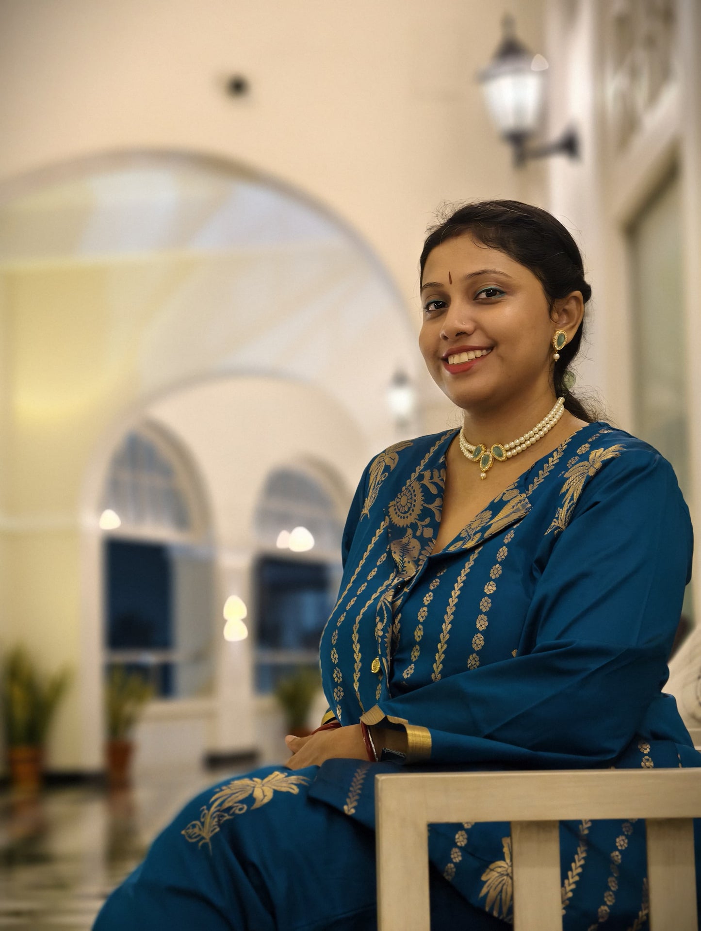Woman wearing a kundan choker necklace for women from Anusangi Collections with traditional blue outfit