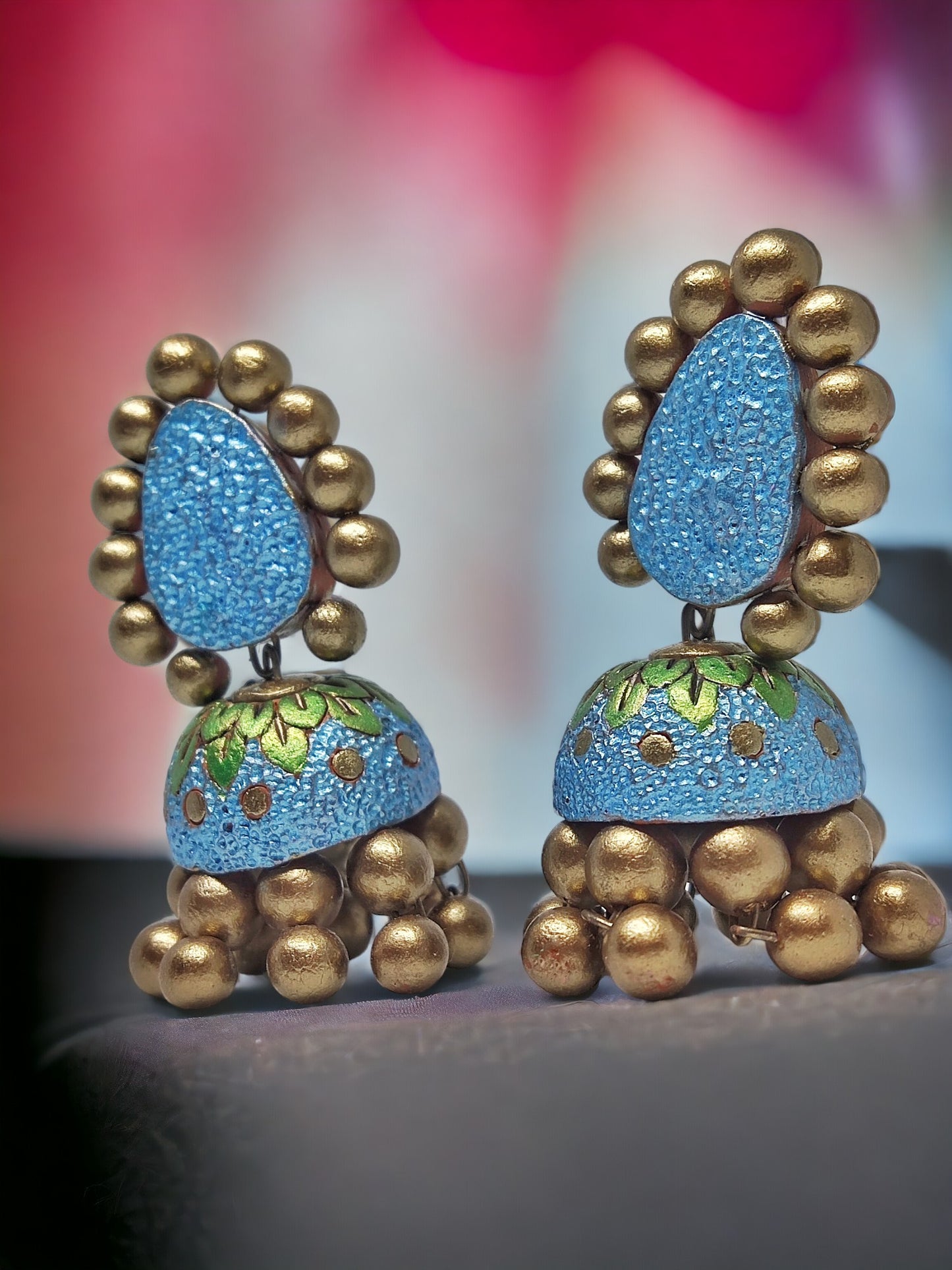 Lakshita terracotta jhumka earrings in blue and gold with intricate detailing from Anusangi Collections