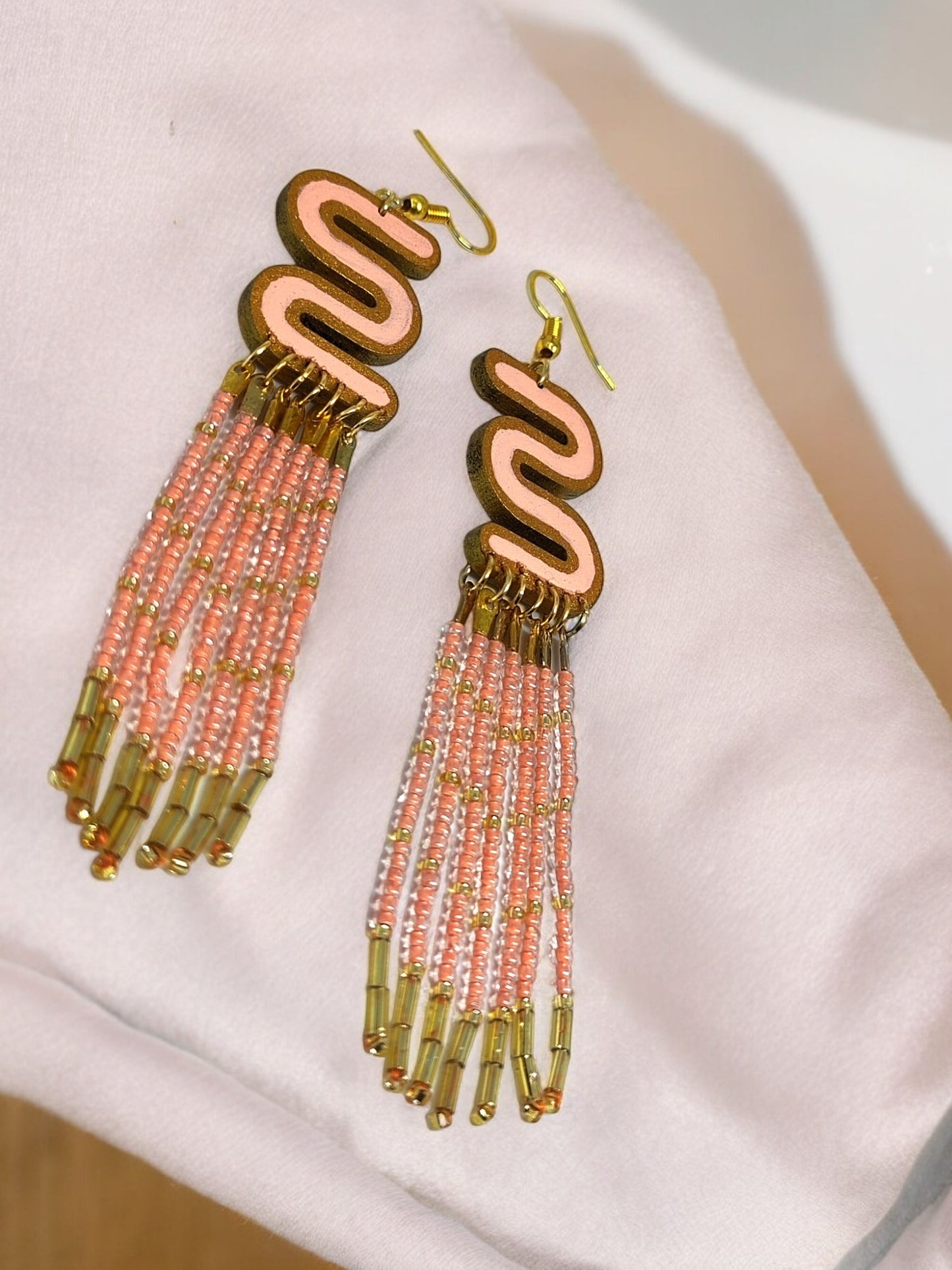 Long beaded earrings for women with pink and gold beads and unique wavy top design by Anusangi Collections