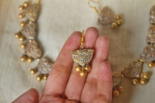 Anusangi Collections terracotta jewelry set featuring a lustrous necklace for special occasions with intricate gold detailing
