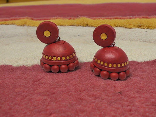 Maroon and gold terracotta earrings by Anusangi Collections with round design and decorative dots