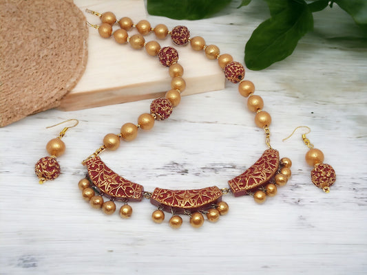 Nysa terracotta necklace and matching earrings set from Anusangi Collections with gold and red intricate design