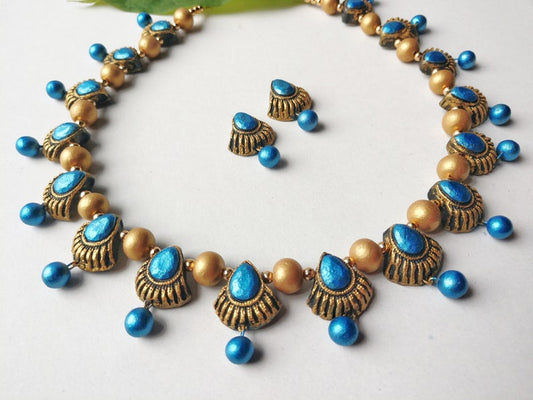 Terracotta jewelry set from Anusangi Collections featuring Ocean Blue Carapace Necklace with matching earrings