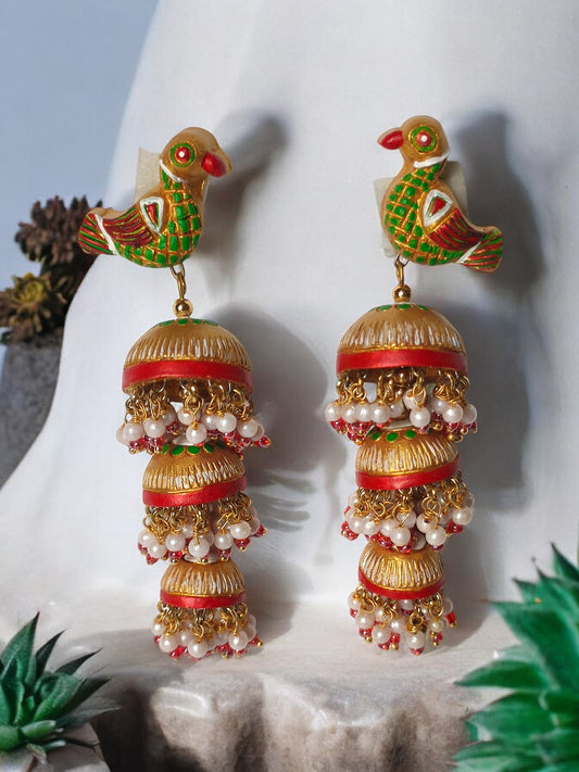 Parrot motif terracotta jhumka earrings with green and red hand-painted details and pearl accents