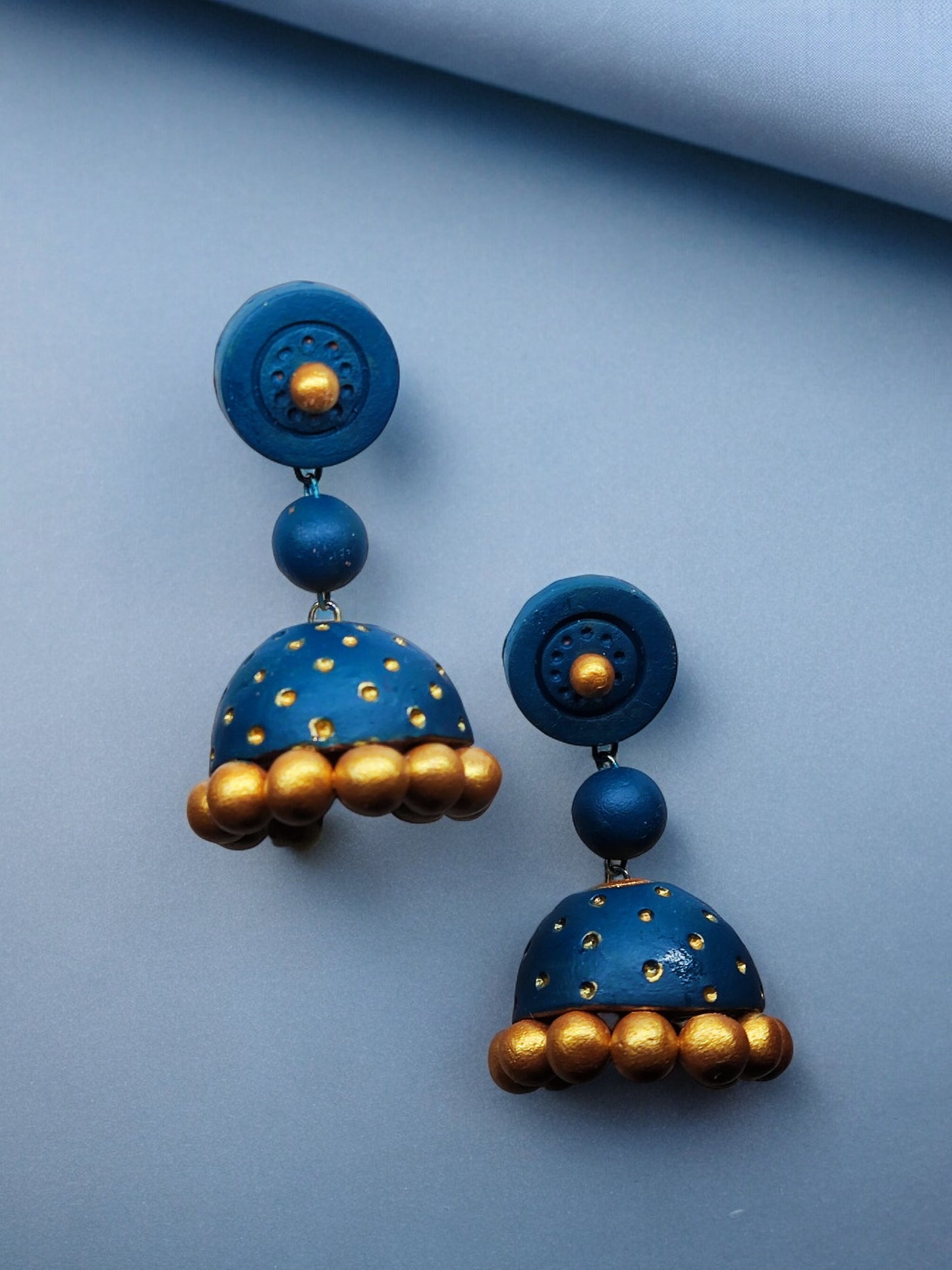 Peacock blue terracotta jhumka earrings with gold accents from Anusangi Collections