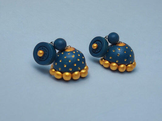 Peacock blue terracotta jhumka earrings with gold accents from Anusangi Collections on a light blue background