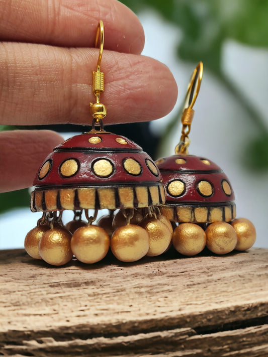 Rambha Jhumka Terracotta Earring by Anusangi Collections featuring red and gold design with hanging golden beads