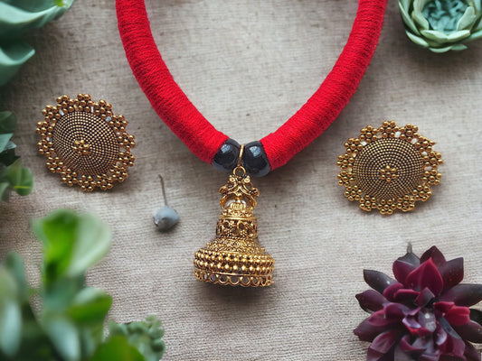 Anusangi Collections red and gold jewelry set with beaded red necklace and intricate gold earrings