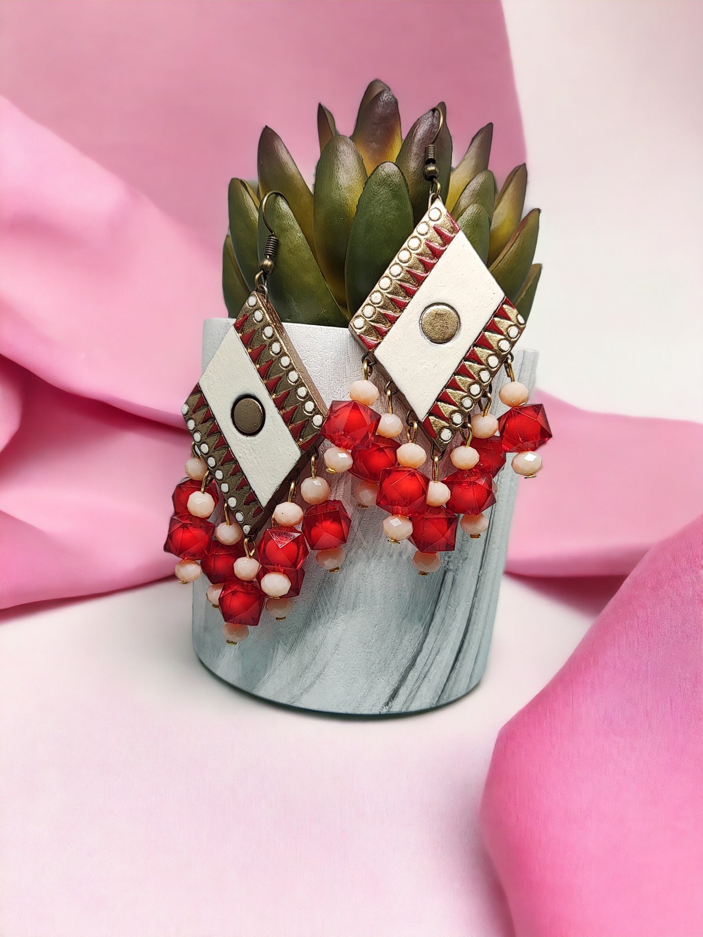 Anusangi Collections red terracotta earrings with geometric design and bead detailing