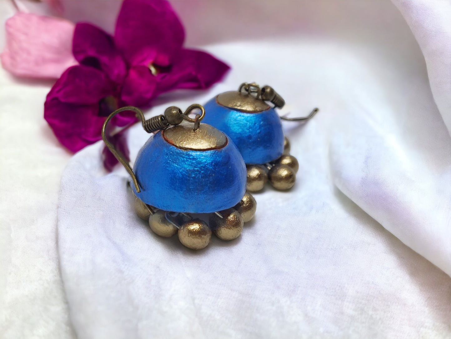 Royal blue jhumka earrings made of terracotta with antique gold accents from Anusangi Collections