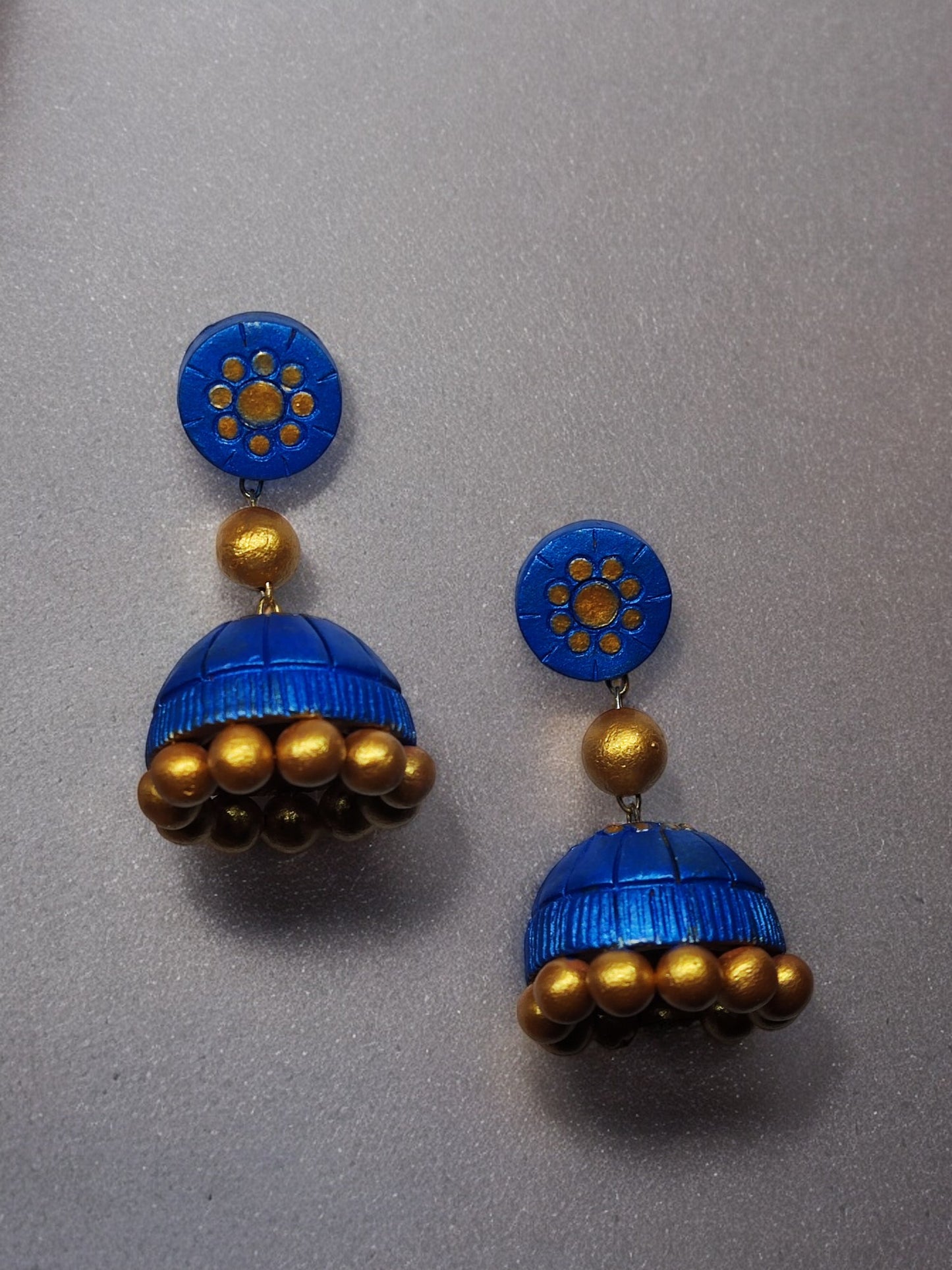 Royal blue terracotta jhumka earrings with golden bead accents from Anusangi Collections