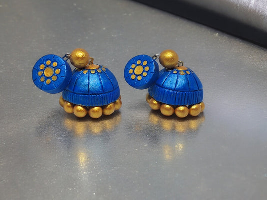 Anusangi Collections royal blue terracotta jhumka earrings with gold accents and floral design