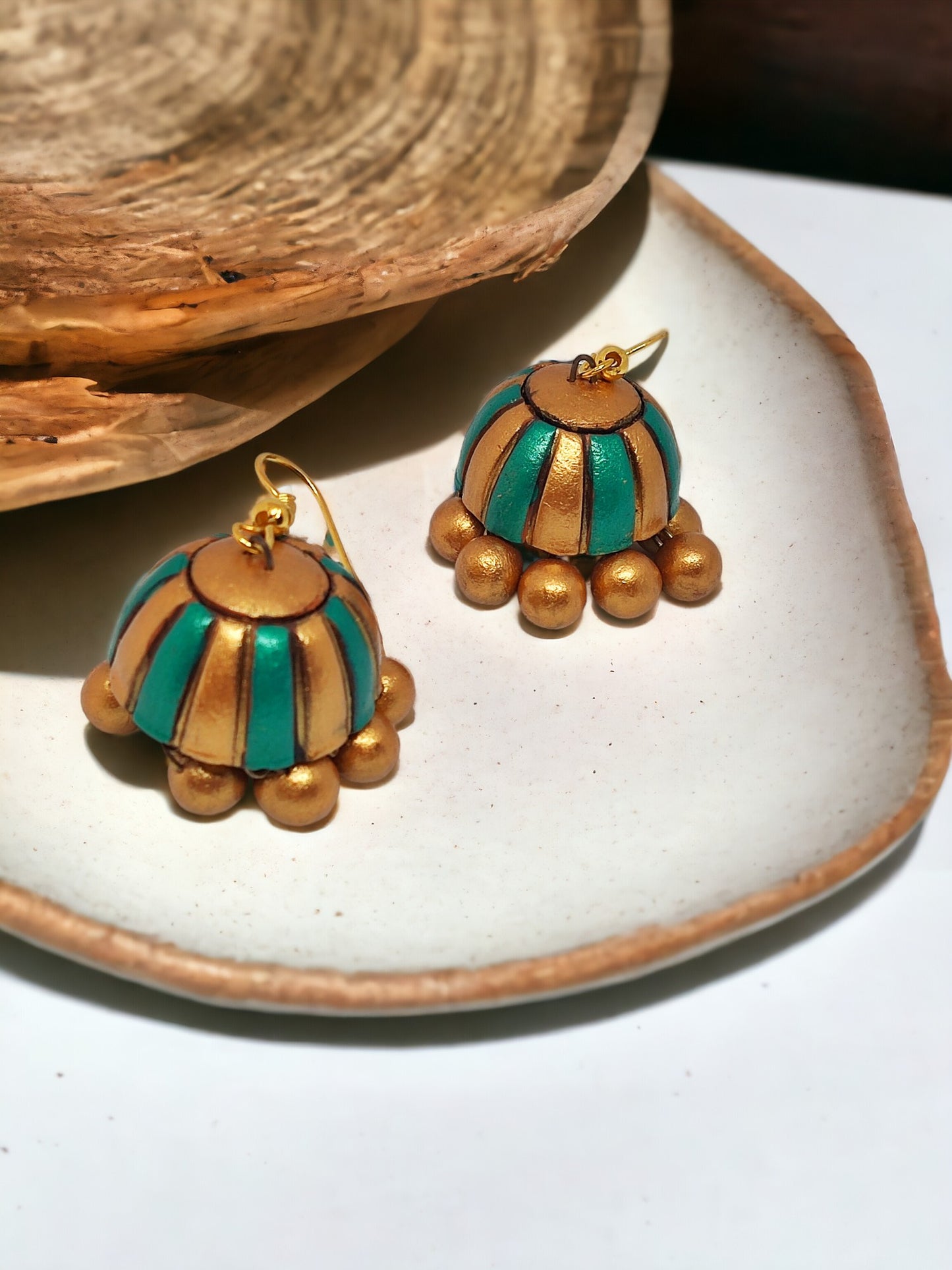 Saumya terracotta jewelry from Anusangi Collections featuring green and gold striped terracotta earrings with round golden beads