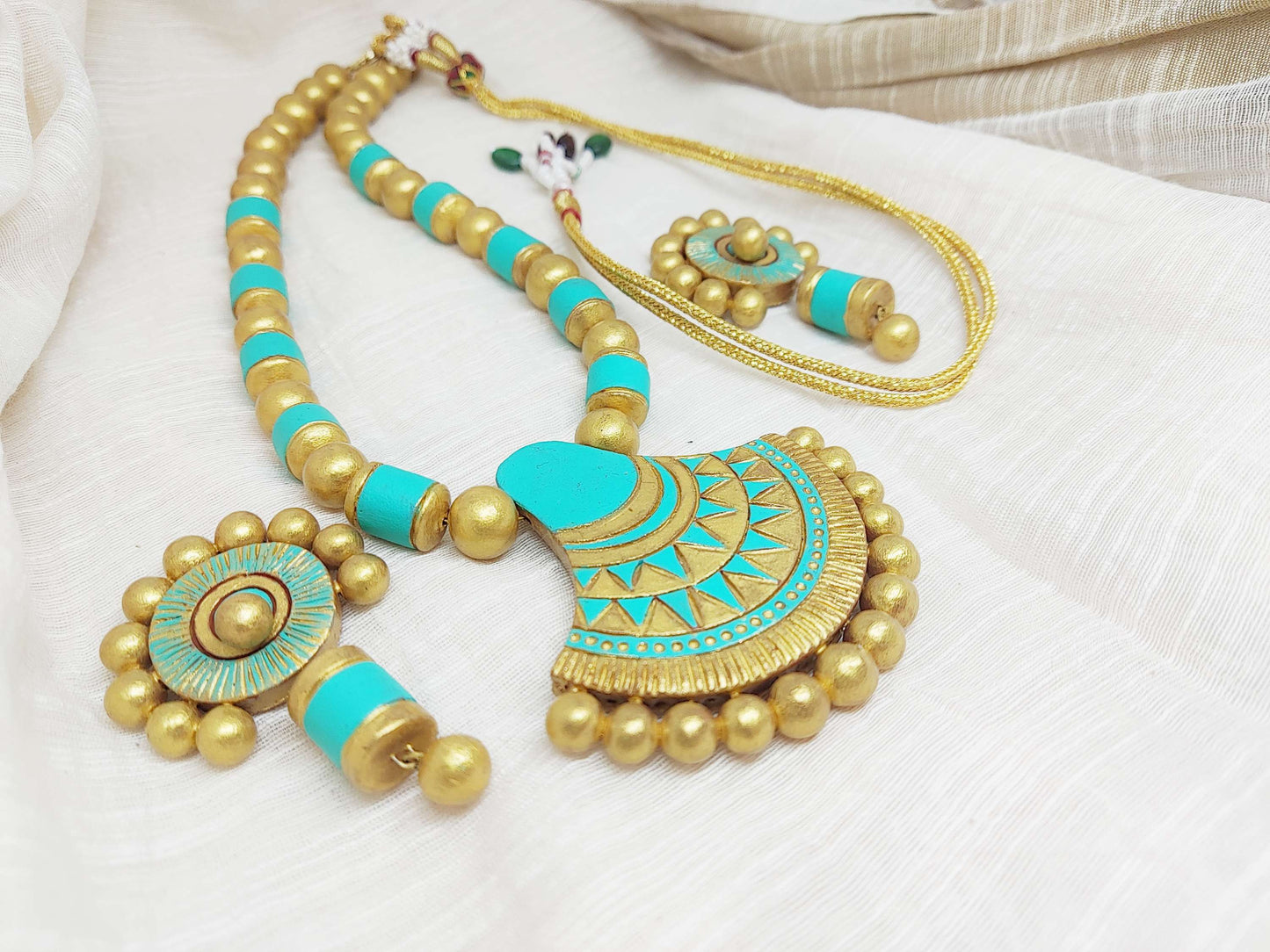 Anusangi Collections sea green terracotta jewelry set with necklace and earrings in intricate gold and turquoise design