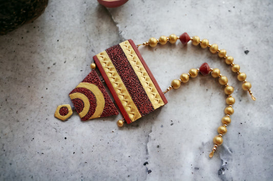 Shravya Terracotta necklace and earrings from Anusangi Collections featuring red and gold intricate design