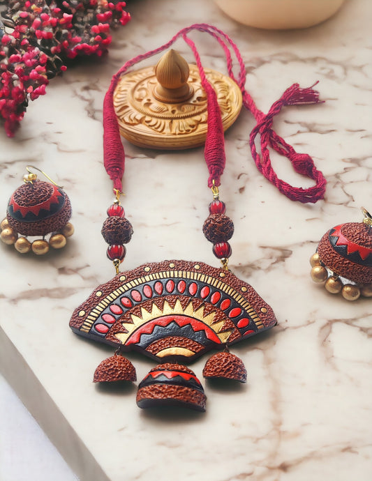 Siara terracotta jewelry set by Anusangi Collections featuring handmade necklace and matching earrings in red and brown tones