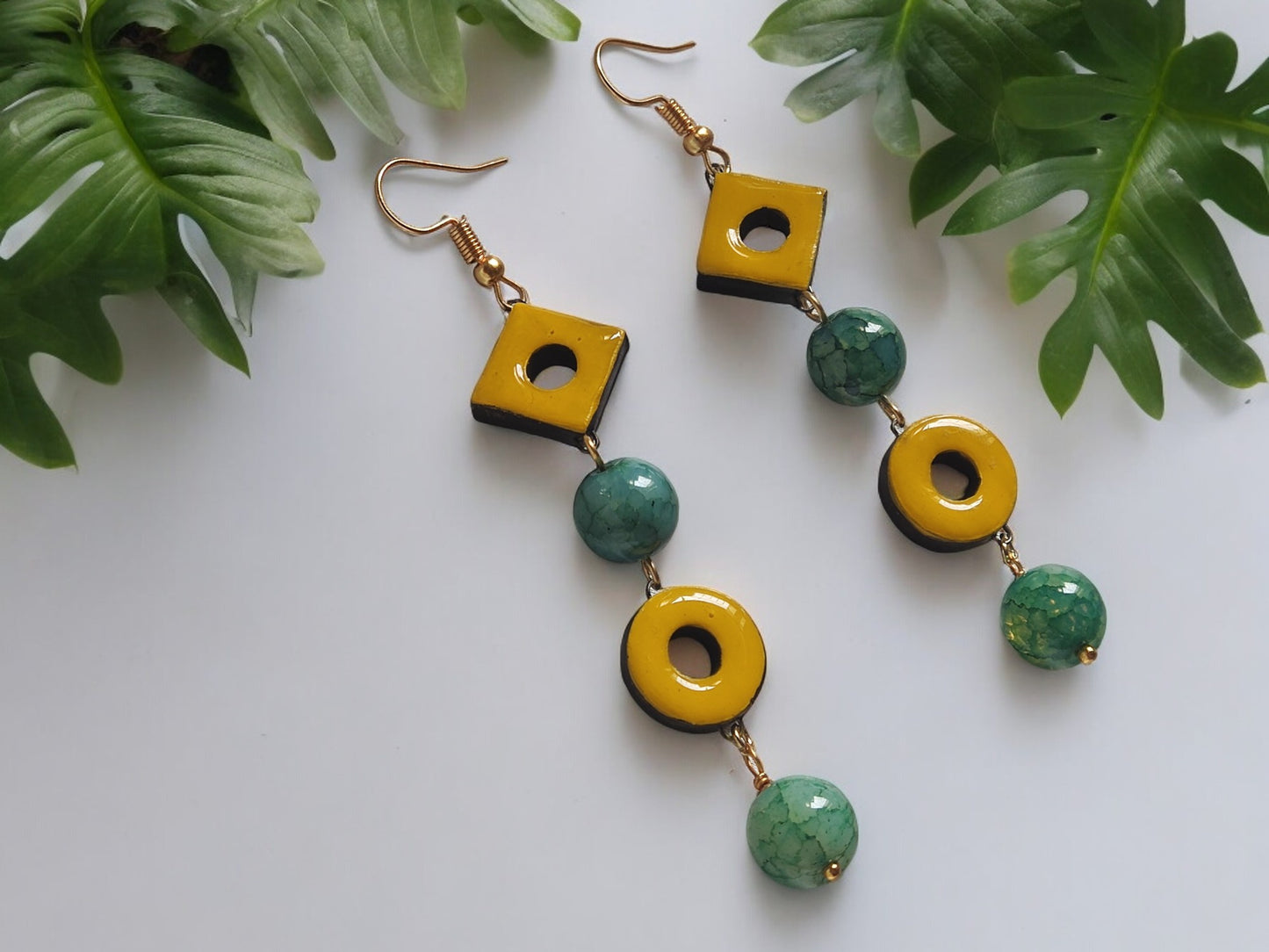 Anusangi Collections yellow and green statement terracotta earrings with geometric design and hook closures