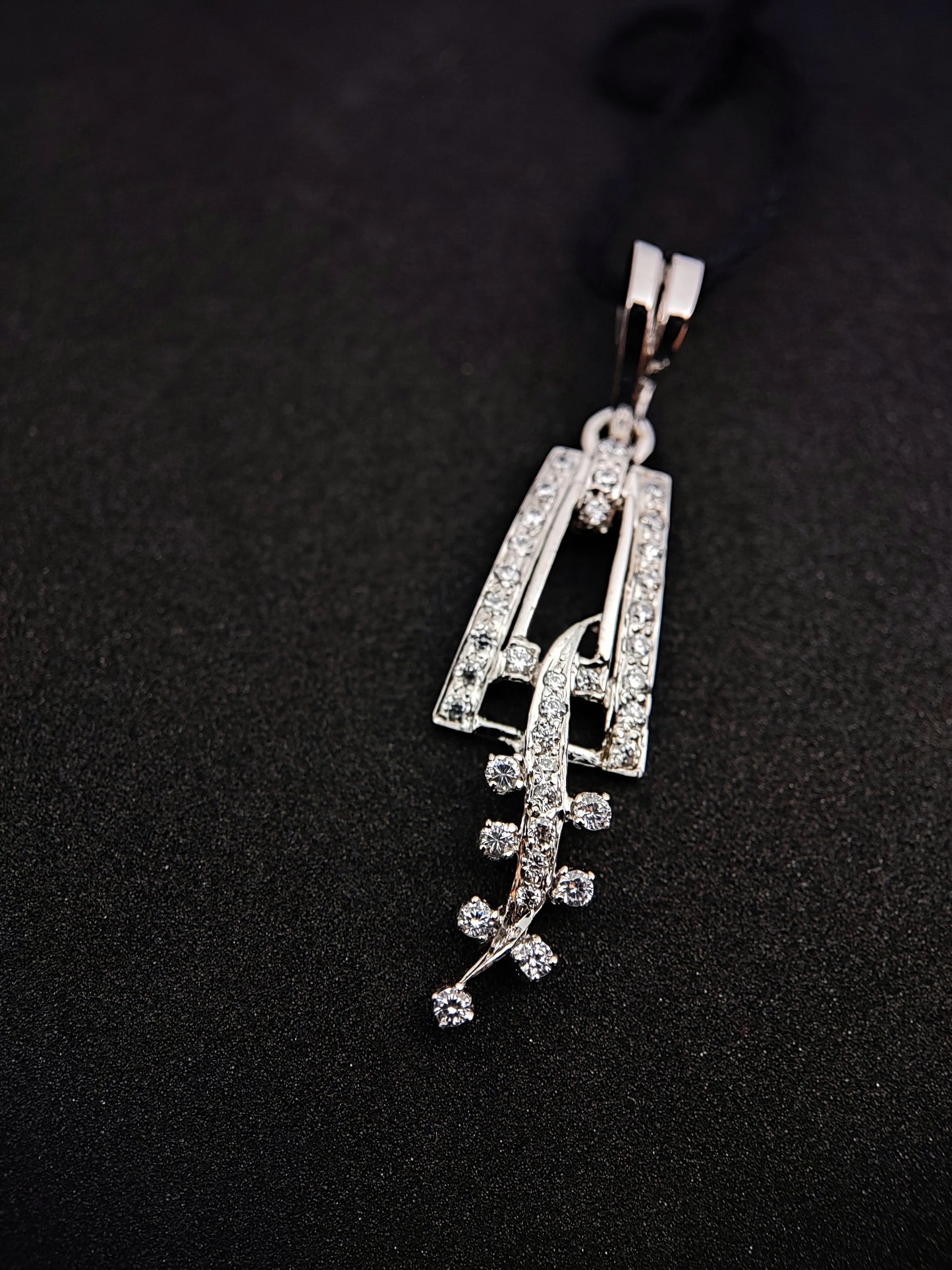 Sterling silver leaf pendant with sparkling stones from Anusangi Collections on black background