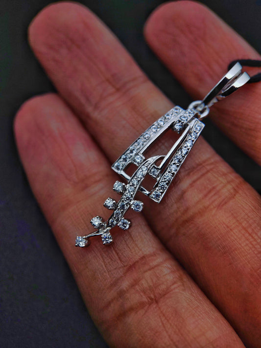 Sterling silver leaf pendant with sparkling stones from Anusangi Collections held on a hand