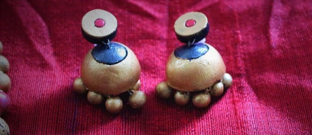Anusangi Collections terracotta earrings matching Sudarshana necklace handmade on red fabric