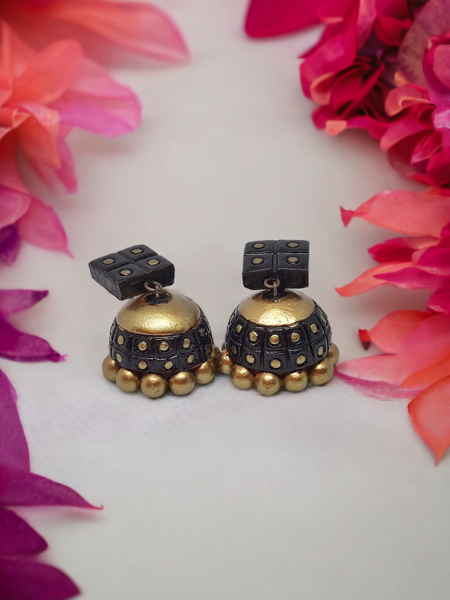 Black and gold Terracotta Anaya Jhumka earrings from Anusangi Collections with intricate detailing