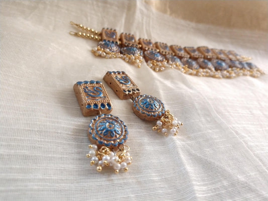 Anusangi Collections terracotta jewelry set featuring a traditional fabric choker necklace with blue and gold accents and matching earrings