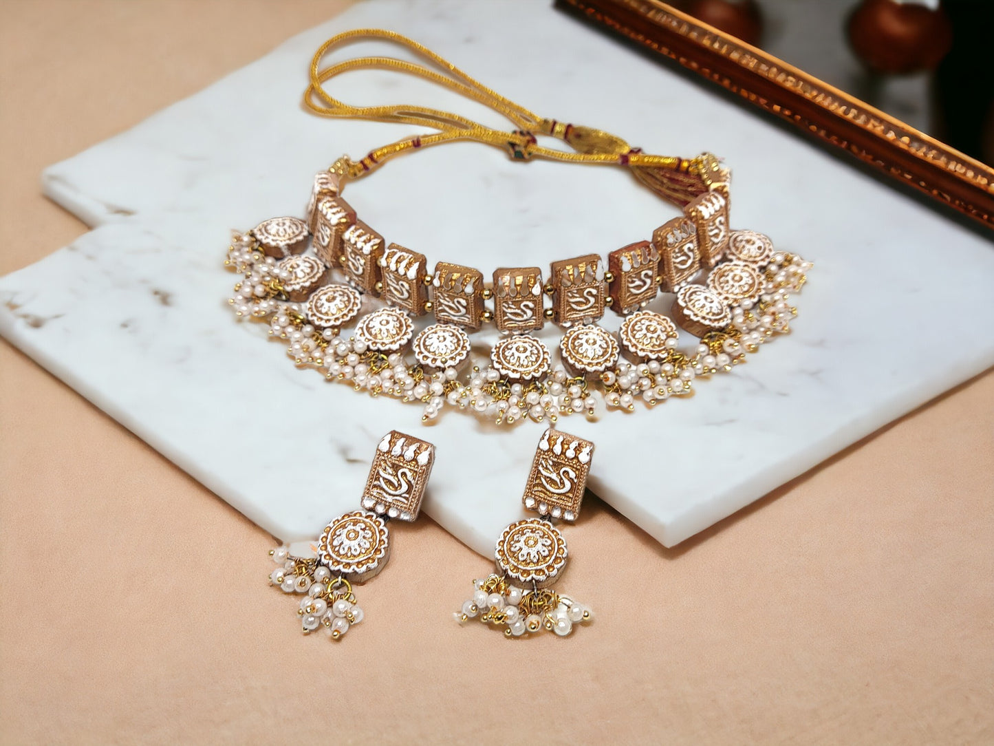 Anusangi Collections terracotta jewelry set featuring traditional fabric choker necklace with matching earrings and pearl accents