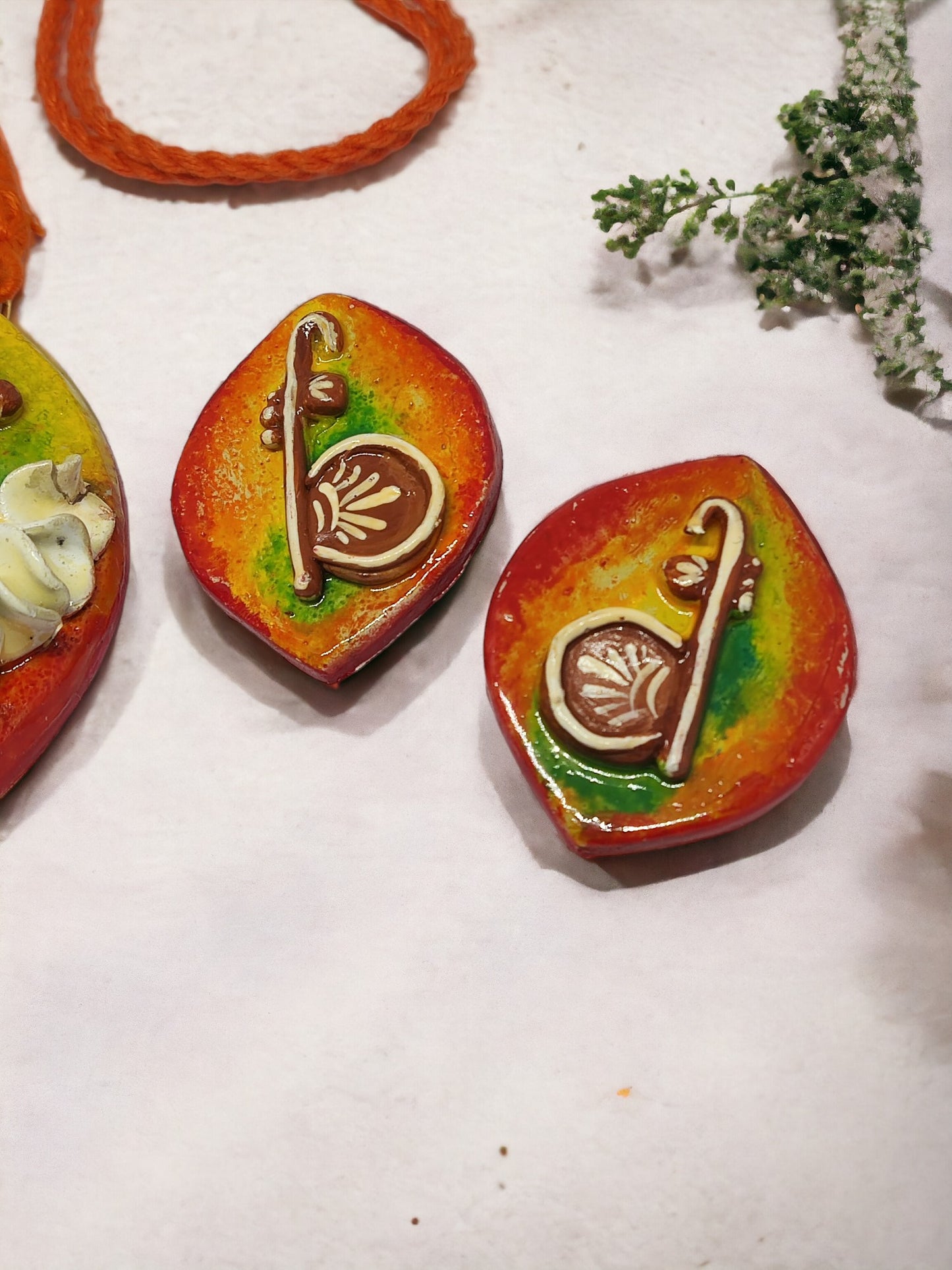 Traditional Rajhans pendant set for women from Anusangi Collections with vibrant orange and green fabric jewelry