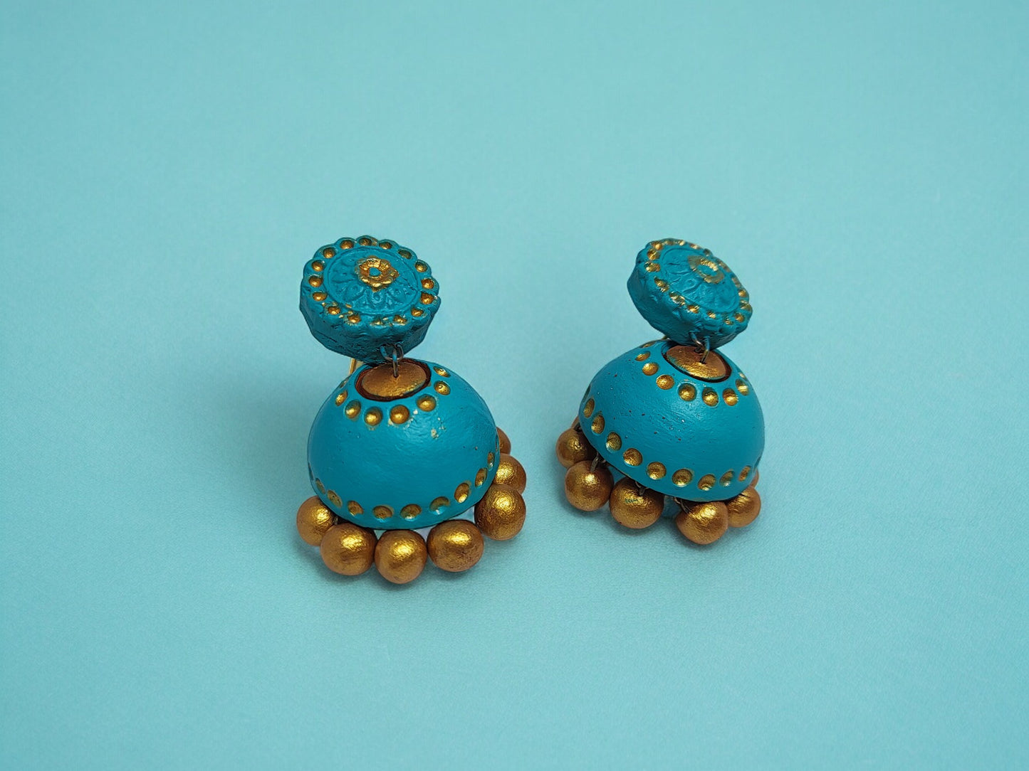 Turquoise blue terracotta earrings with golden bead detailing from Anusangi Collections