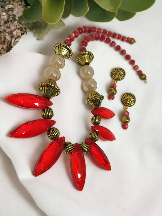 Unique red statement necklace set with large red beads and antique gold accents by Anusangi Collections