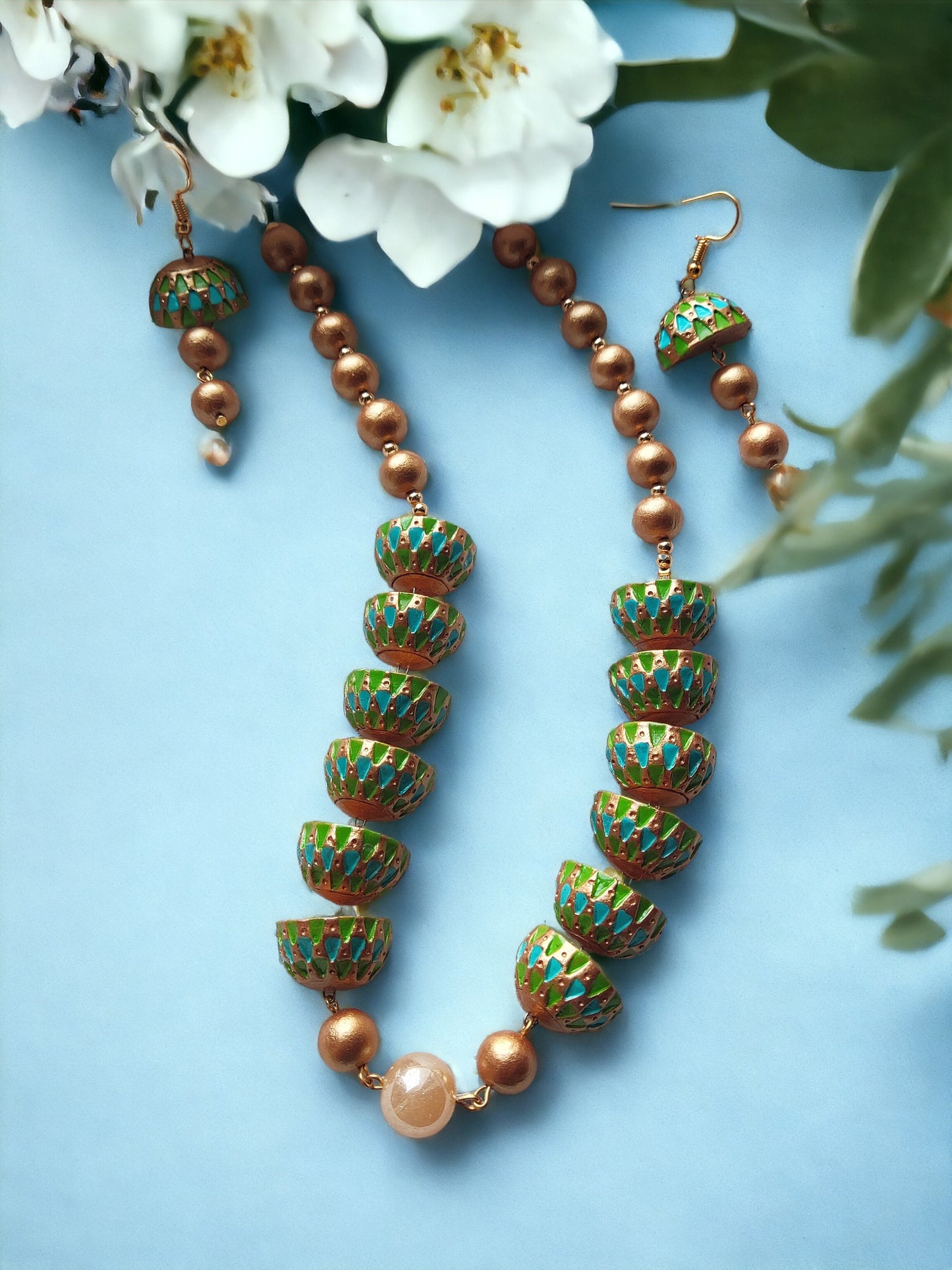 Unique terracotta earrings and necklace set from Anusangi Collections with green and copper bead design