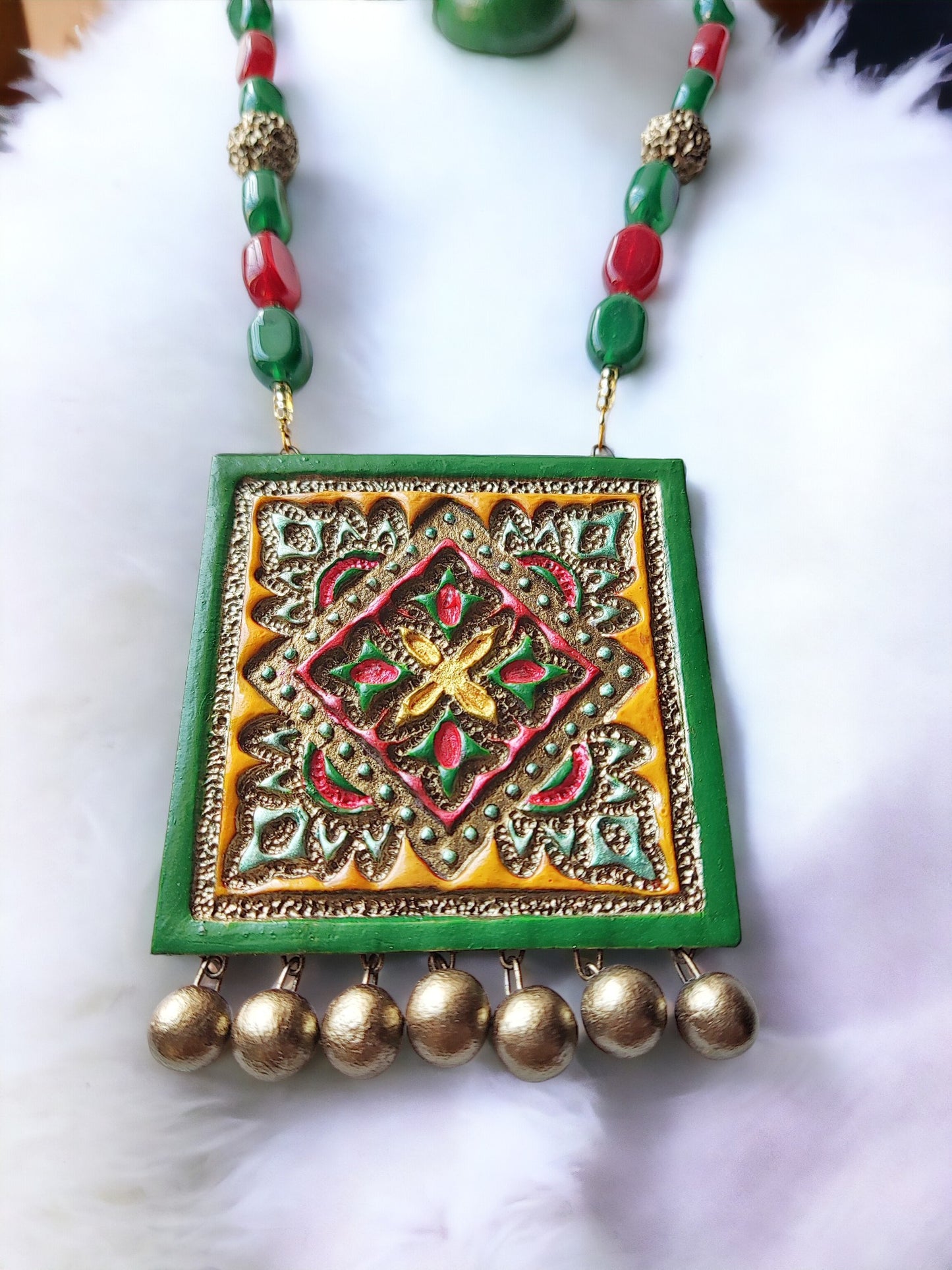 Vasudha terracotta necklace and earrings set with green red beads and intricate square pendant design