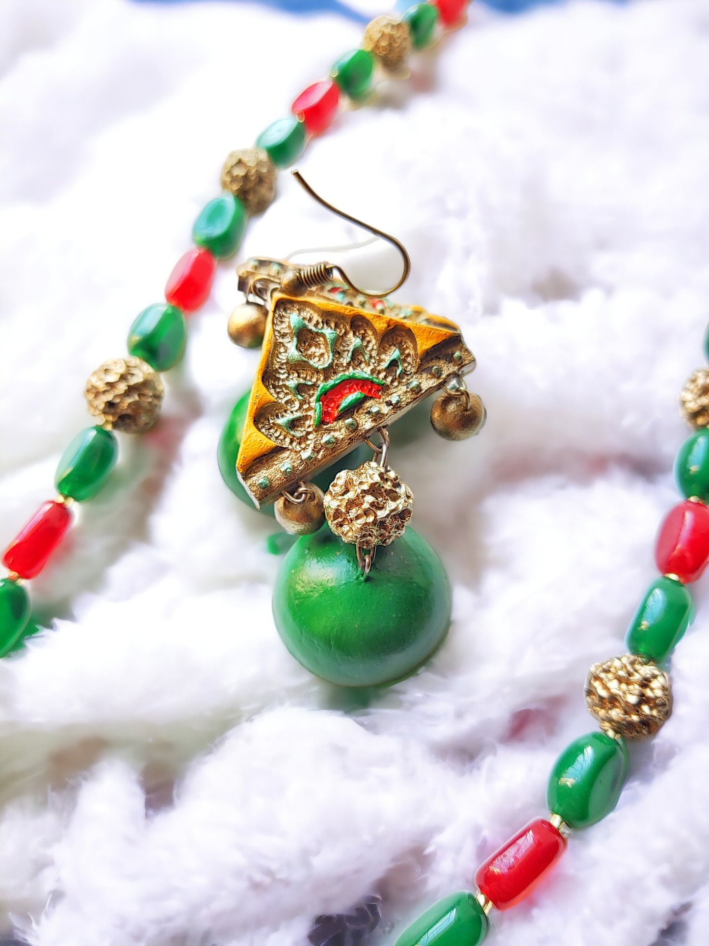 Vasudha terracotta necklace and earrings set with green and red beads and intricate gold detailing