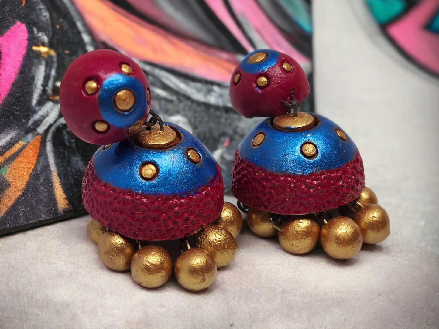 Vasundhara terracotta earrings in blue and red with golden bead detailing from Anusangi Collections