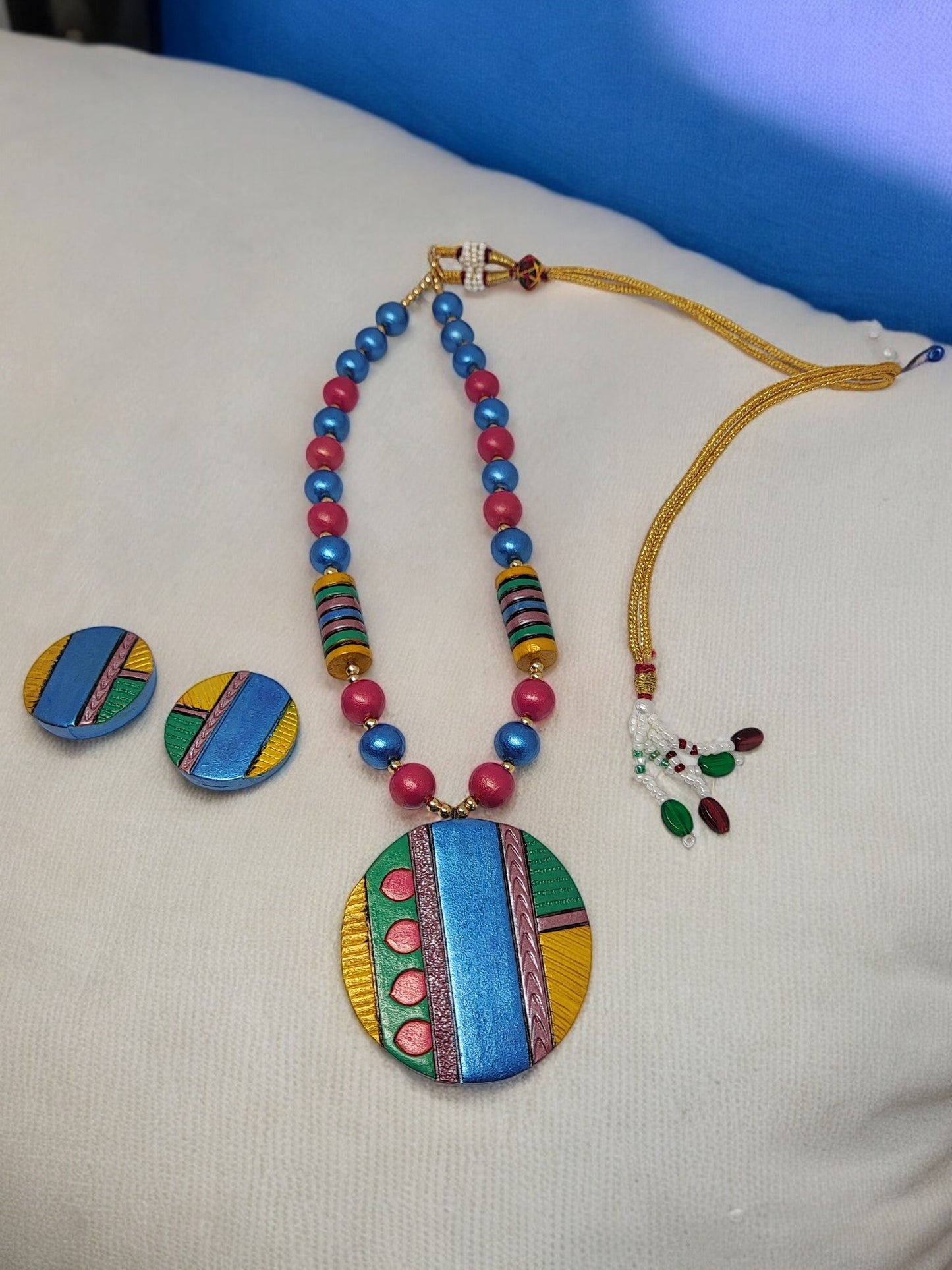 Colorful Atishi necklace and earrings terracotta jewelry set with vibrant blue, pink, green, and yellow patterns