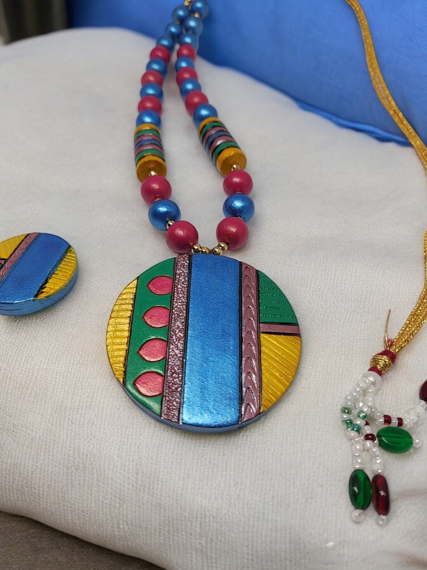 Colorful Atishi necklace and earrings terracotta jewelry set by Anusangi Collections with vibrant blue pink and green tones