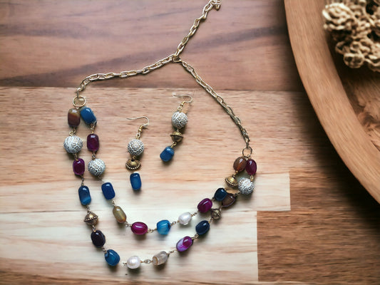 Anusangi Collections double layer handmade necklace with colorful beads and matching earrings on wooden surface