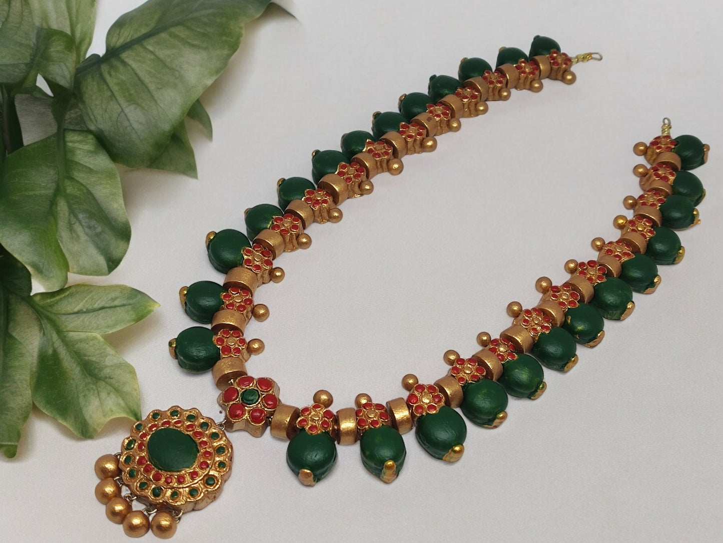 Grand terracotta necklace and earrings with green and red accents from Anusangi Collections