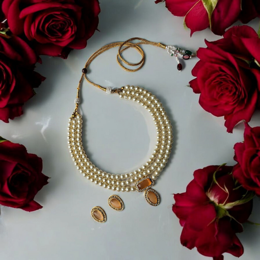 Anusangi Collections traditional Indian choker for wedding with white beads and gold accents surrounded by red roses