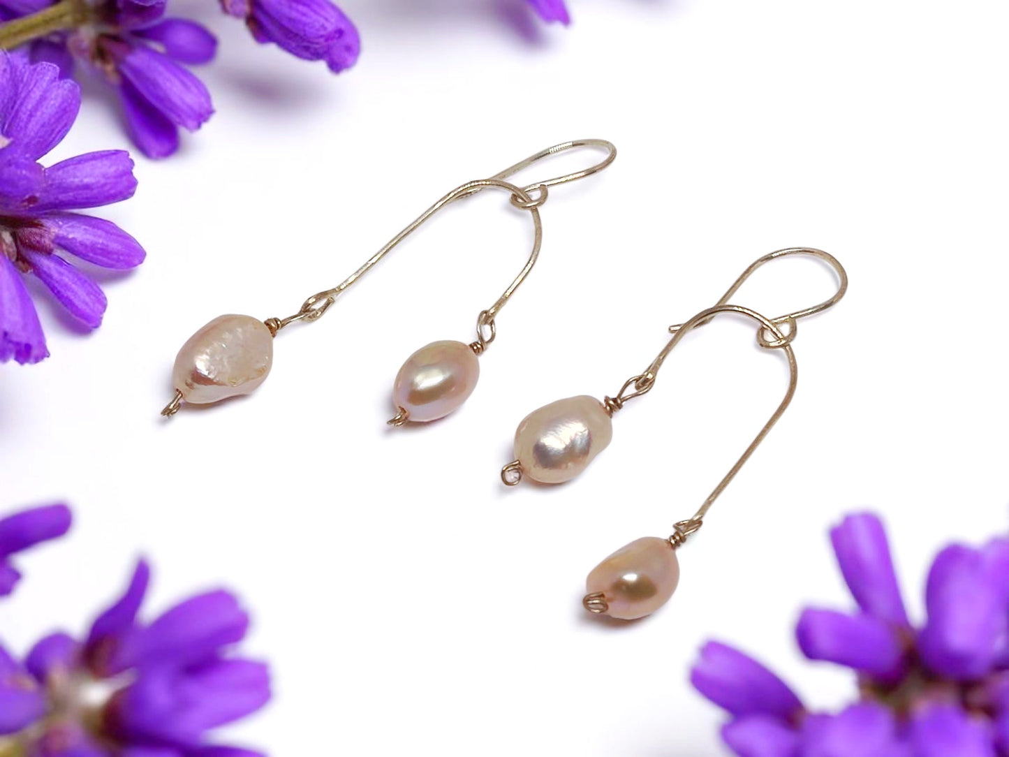 Sterling silver wire pearl earrings for women with elegant teardrop-shaped pearls and delicate floral background