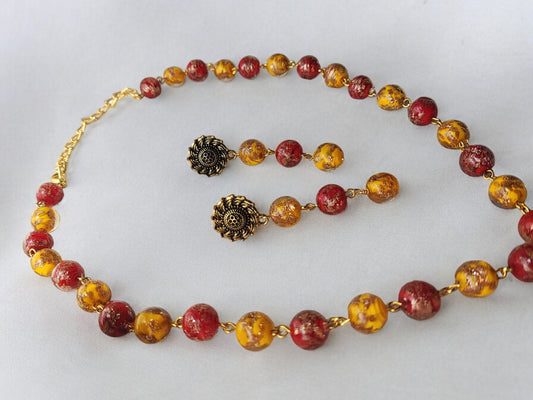 Anusangi Collections yellow red handmade jewelry set featuring beaded necklace and matching earrings