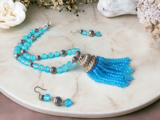 Expertly crafted with stunning blue beads, the Nilima jewelry set is the perfect accessory to elevate any outfit. Handmade with care, this set exudes elegance and sophistication. The intricate design and high quality materials make it a timeless addition to your collection.