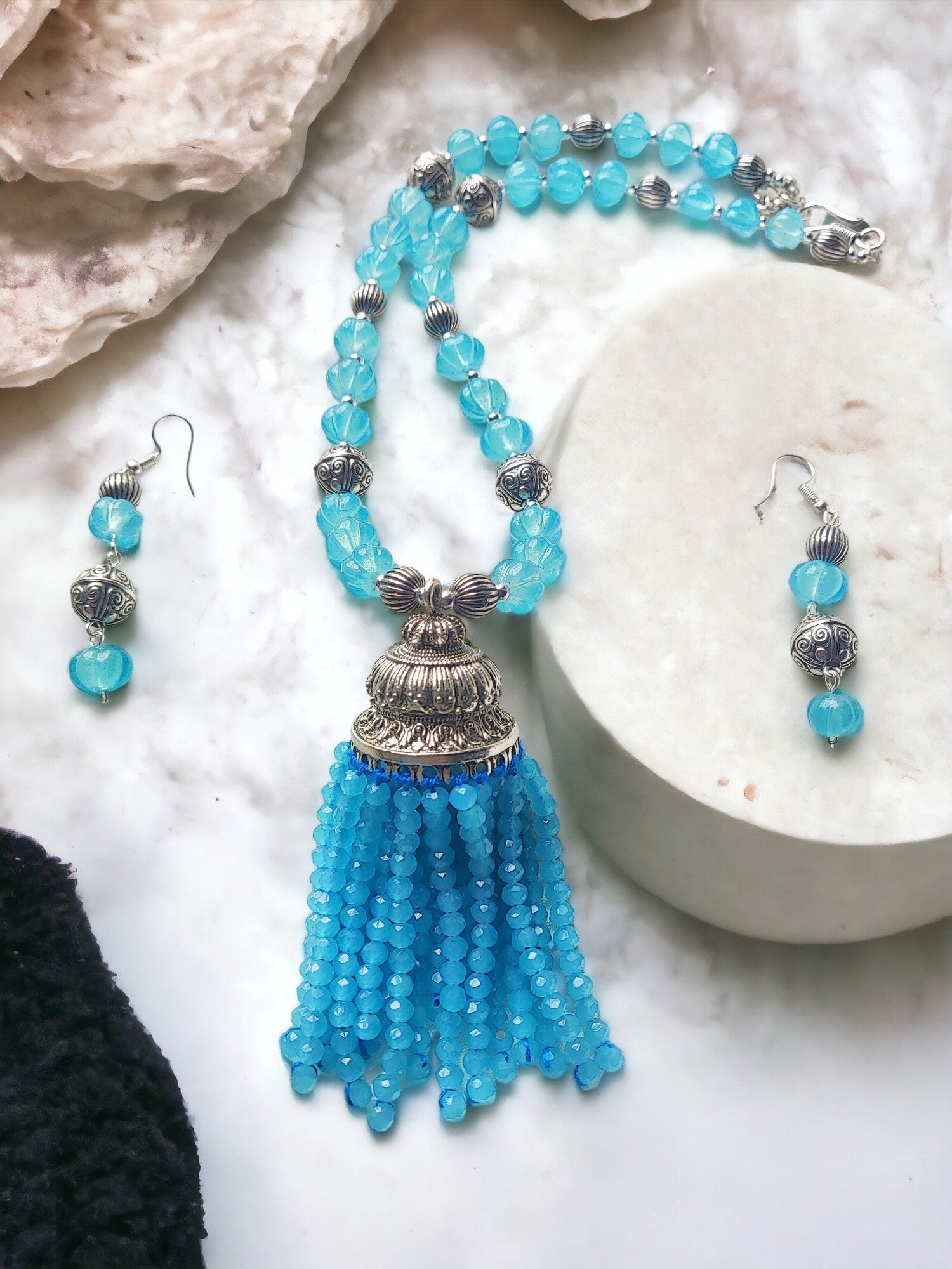 Expertly crafted with stunning blue beads, the Nilima jewelry set is the perfect accessory to elevate any outfit. Handmade with care, this set exudes elegance and sophistication. The intricate design and high quality materials make it a timeless addition to your collection.