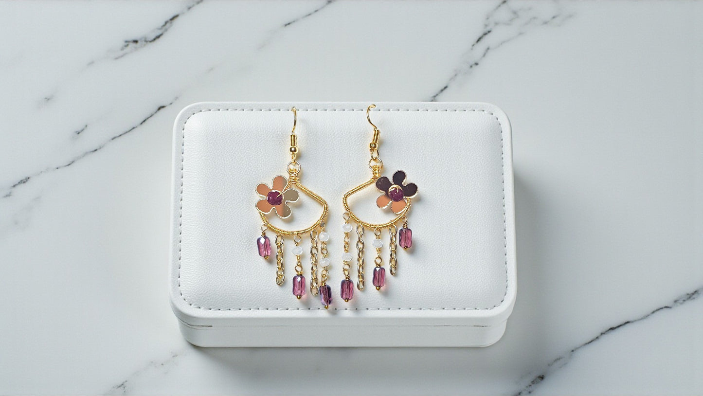 Decorative earrings on a white jewelry box with a marble background