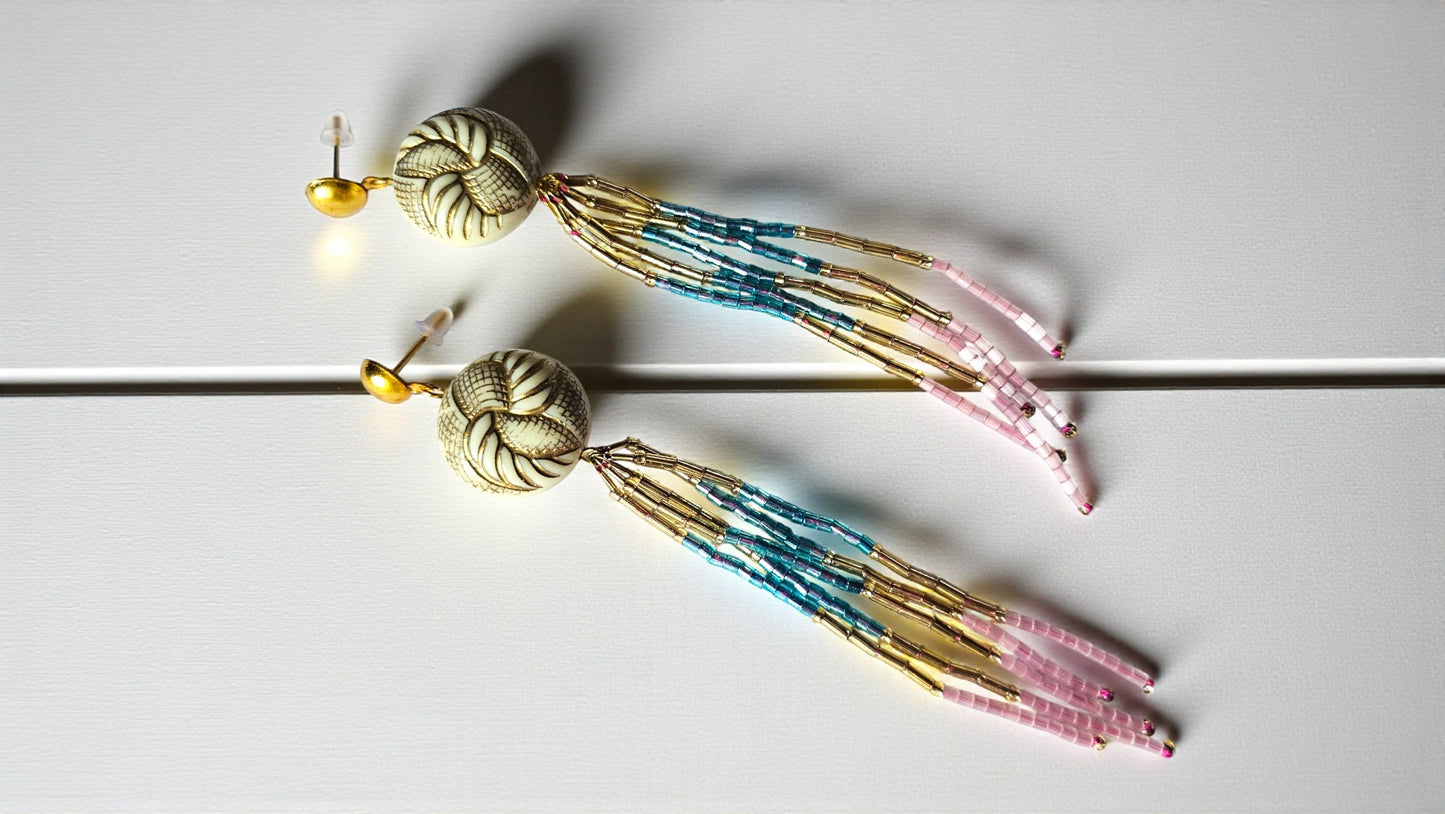 Decorative hair sticks with beads and tassels on a light background