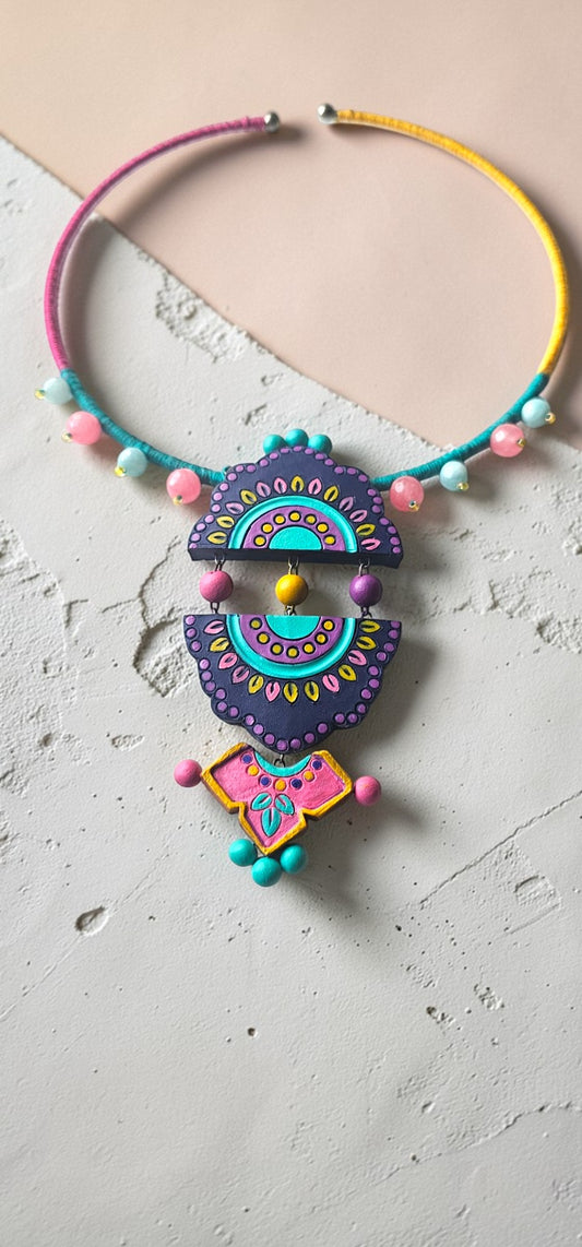 Colorful necklace with decorative elements on a textured surface