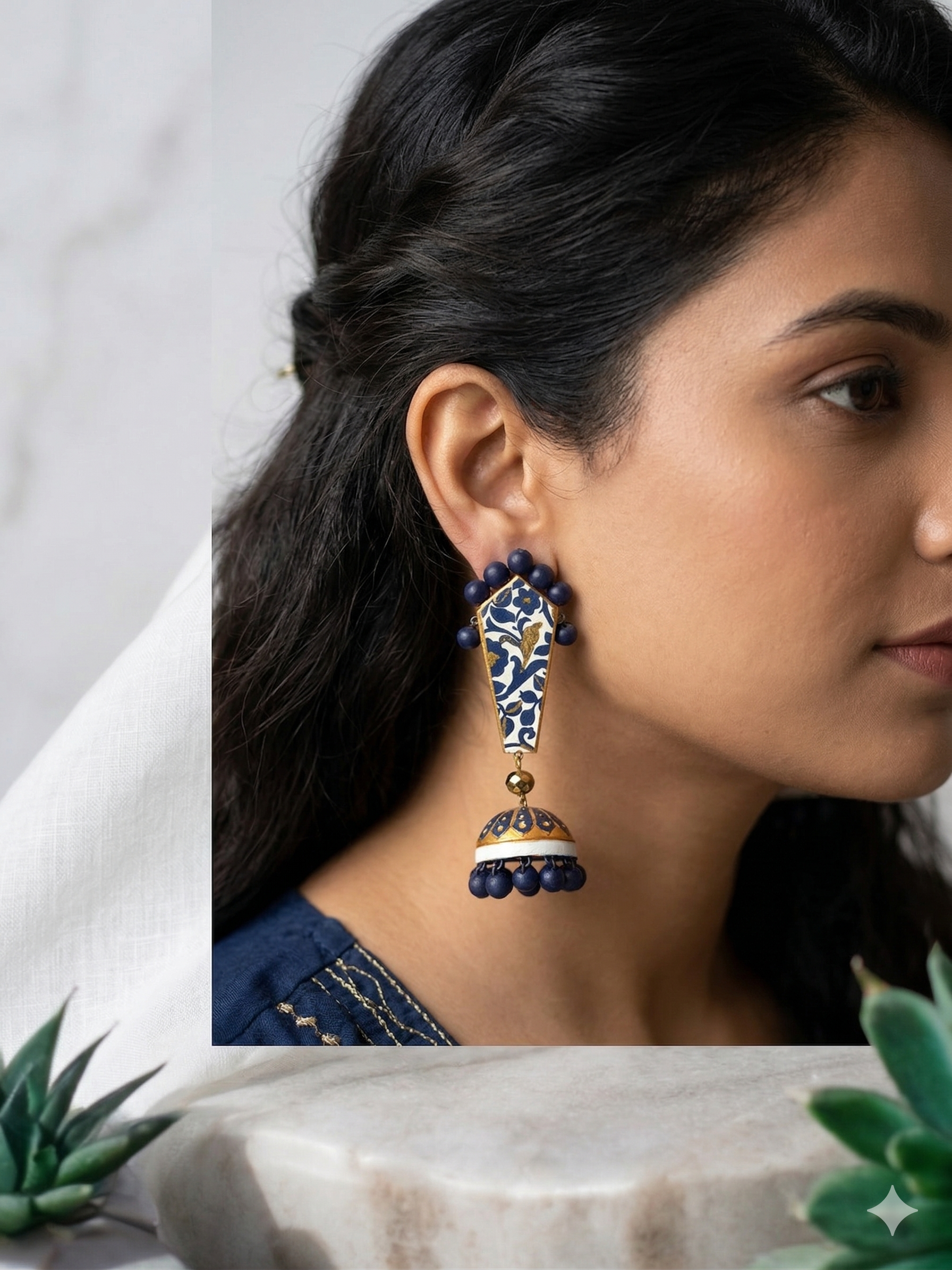 Woman wearing a decorative earring with a neutral background