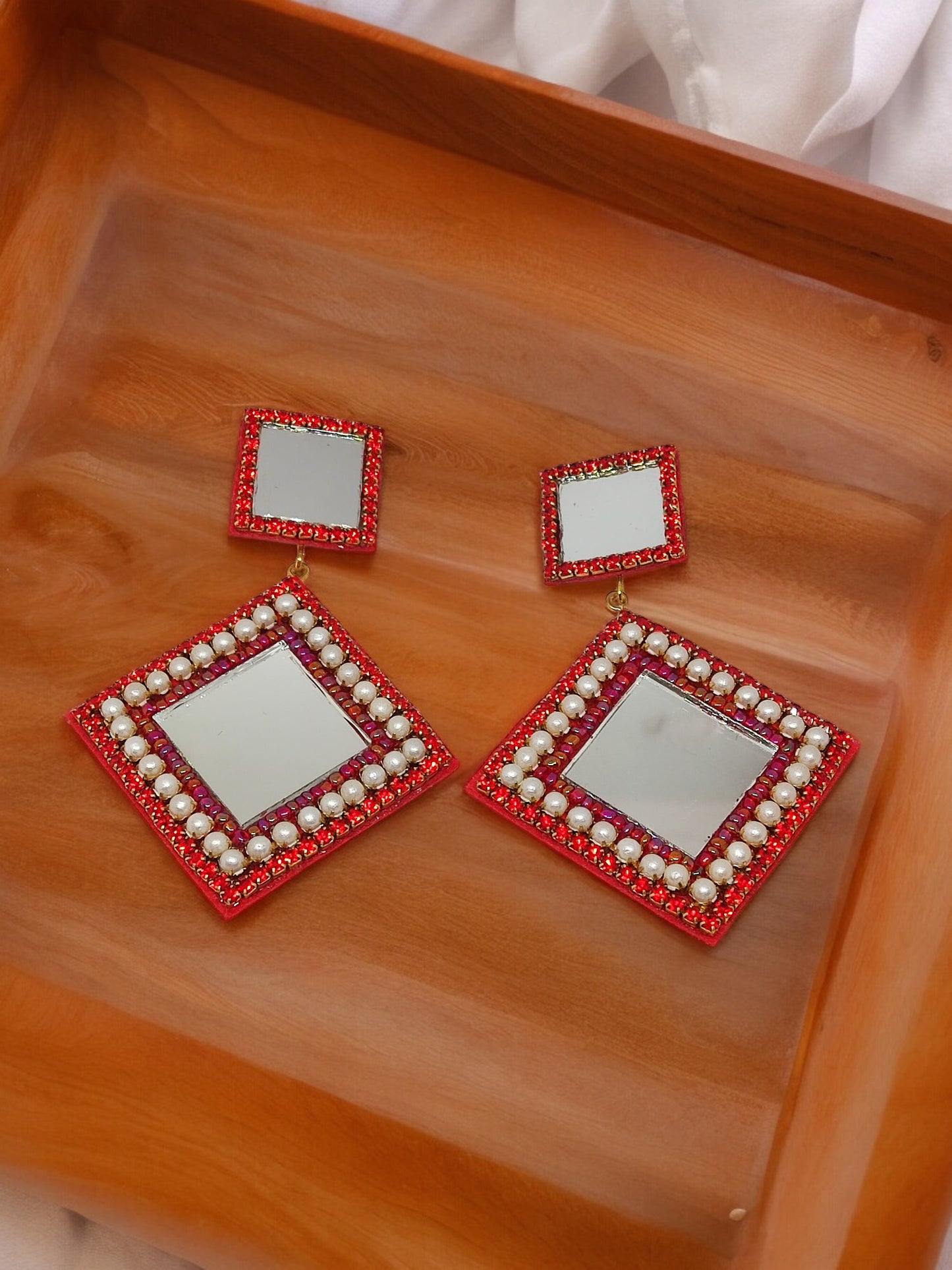 Scarlett Embroidery Earring. These exquisite earrings feature a beautiful combination of embroidery, beads, and mirrors, creating a one-of-a-kind piece that is sure to elevate any outfit. 