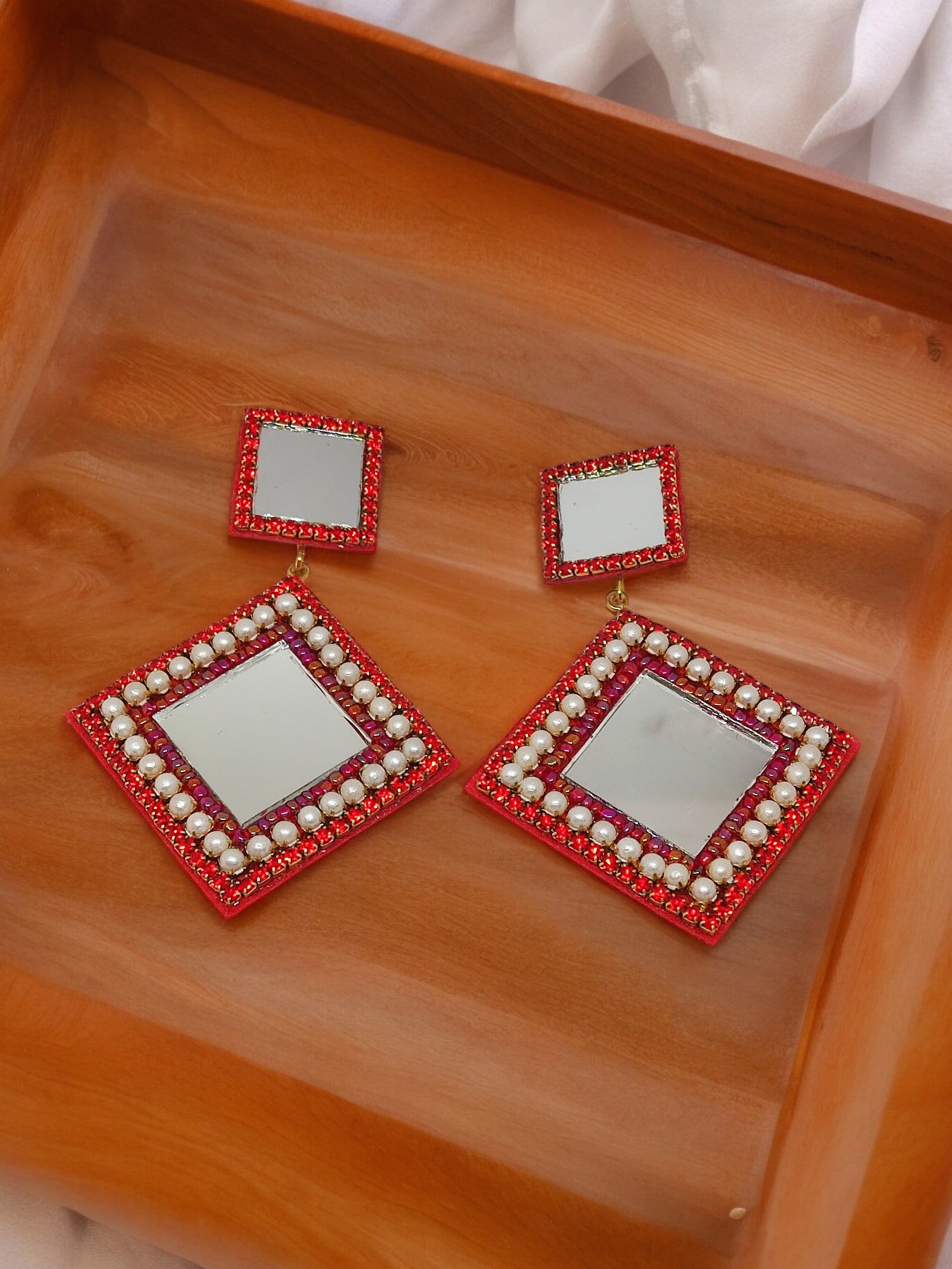 Scarlett Embroidery Earring. These exquisite earrings feature a beautiful combination of embroidery, beads, and mirrors, creating a one-of-a-kind piece that is sure to elevate any outfit. 