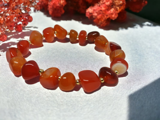 This expertly crafted Orange Nugget bracelet features genuine orange agate nugget beads for a stunning, natural look. With a variety of color options, this bracelet is a versatile accessory that will elevate any outfit. Experience the benefits of wearing beautiful and unique gemstones with this elegant bracelet.
